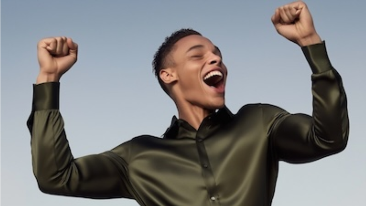 Excited man with arms raised.